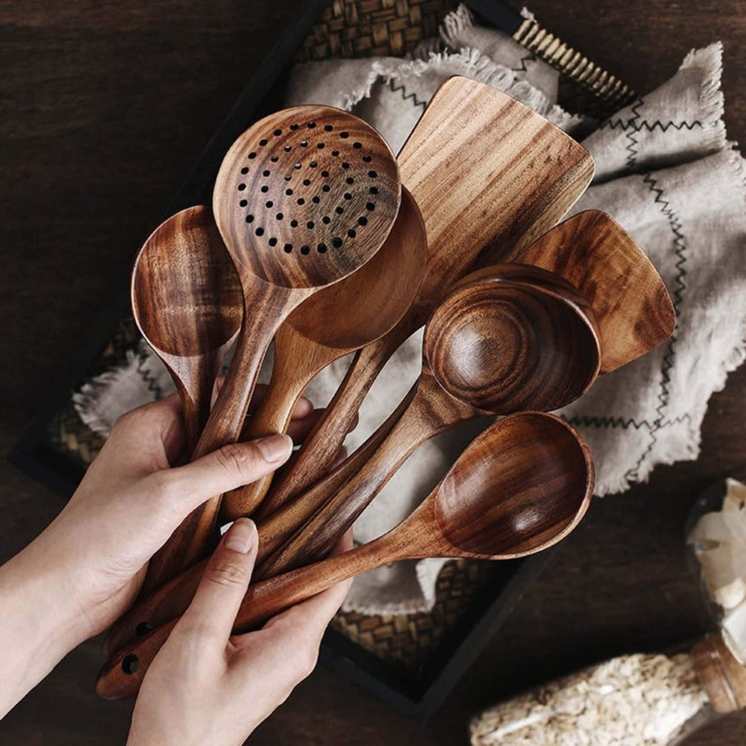 7-piece handcrafted teak wood kitchen utensil set, including spatulas & spoons for cooking & serving.