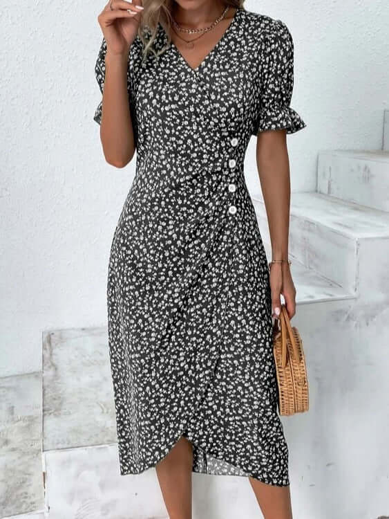 A woman wearing a breezy, flowy knee-length summer dress. Perfect for vacation wear & casual style.