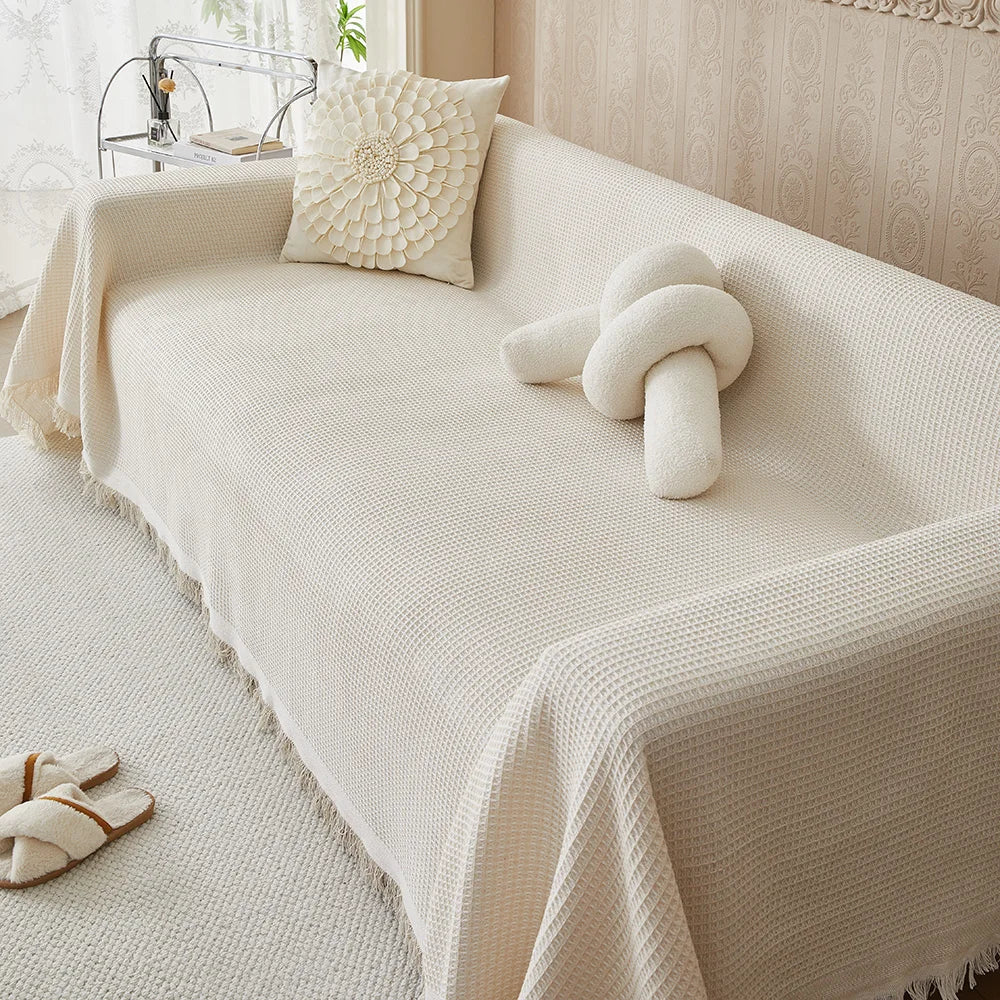 Beige cotton woven sofa cover, oversized furniture protector, washable couch throw for living room decor.