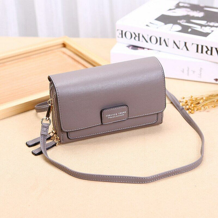 Sophisticated brown leather wallet bag, elegant women's fashion accessory with shoulder strap.