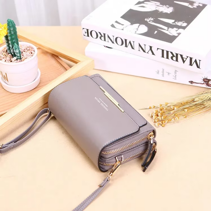 Black leather women's crossbody wallet, featuring a secure zipper and magnetic snap closure.