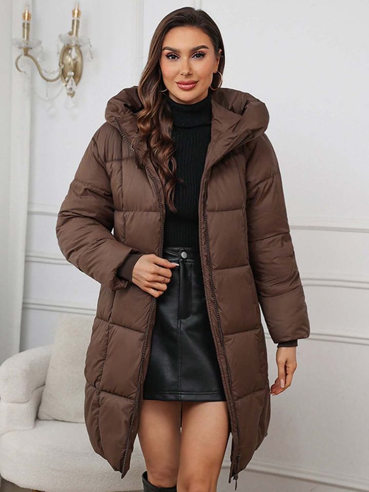 Brown Women's insulated long hooded puffer coat, ideal for cold weather.