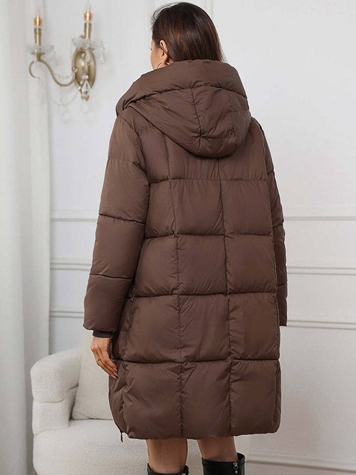 Warm women's long hooded puffer jacket, excellent for harsh winter conditions.