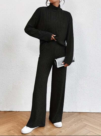 Black women's ribbed knit turtleneck & wide-leg pants set. Cozy two-piece loungewear for comfortable, chic style.
