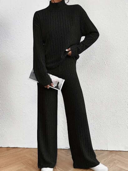Cozy black ribbed knit women's set featuring a turtleneck top & wide-leg pants. Comfortable, relaxed loungewear.