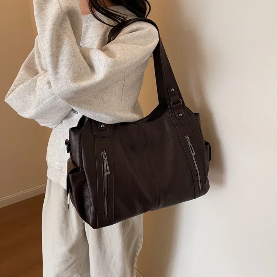 Stylish brown faux leather duffle bag for women, a chic shoulder bag for travel & daily essentials.