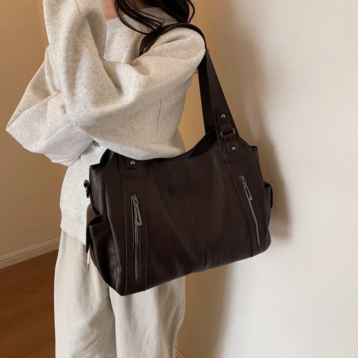Stylish brown faux leather duffle bag for women, a chic shoulder bag for travel & daily essentials.