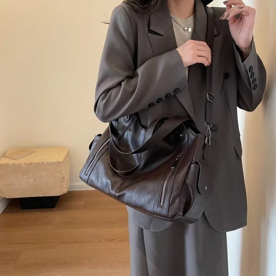 Light brown women's duffle shoulder bag. Versatile faux leather design for organized everyday carry.