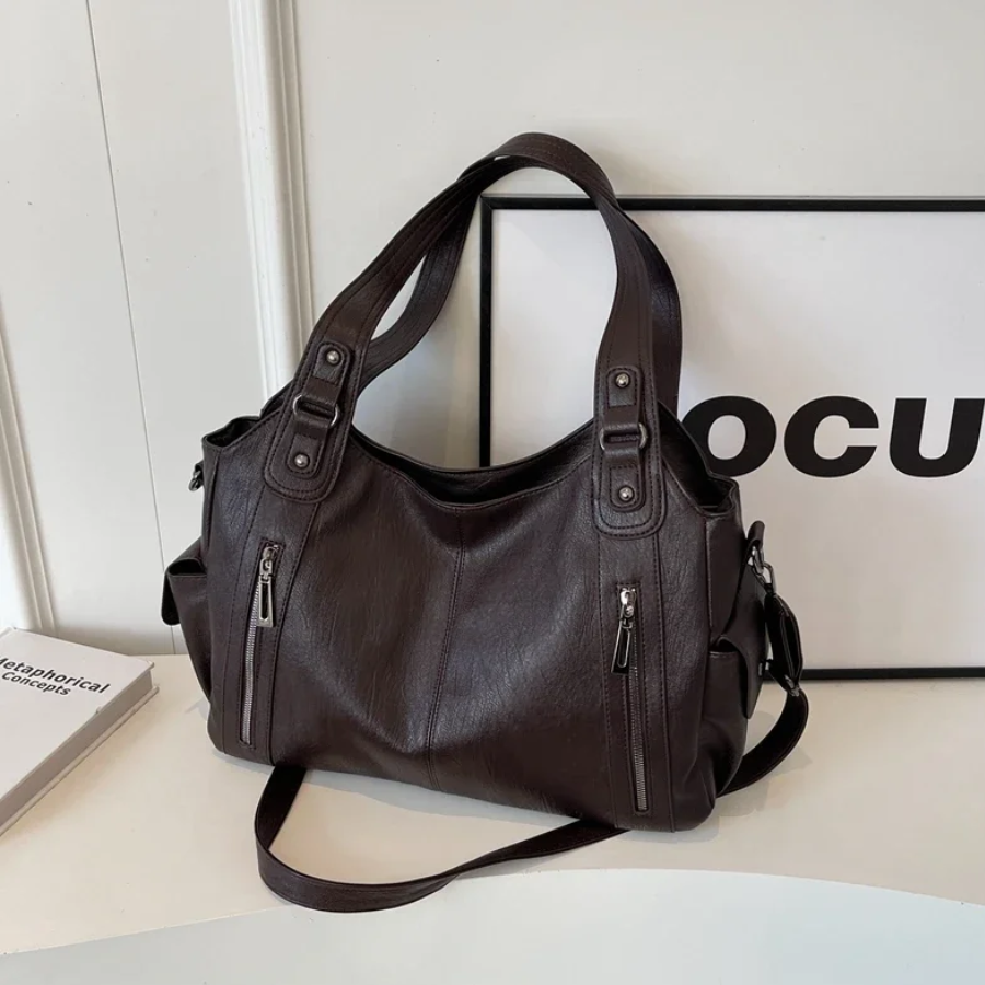 Spacious black faux leather duffle bag, a stylish shoulder bag for women's travel accessories.