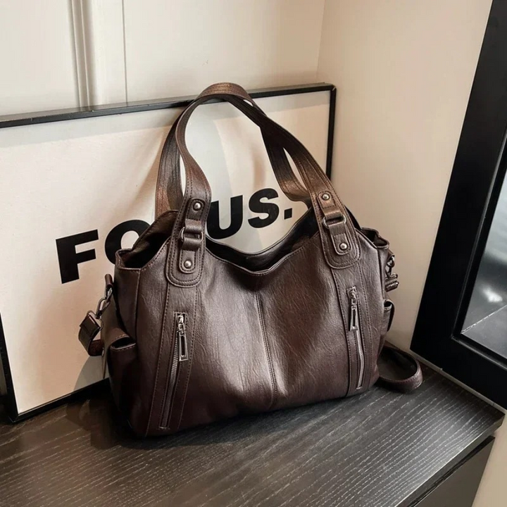 Chic brown faux leather shoulder bag for women, a fashionable duffle for everyday essentials.