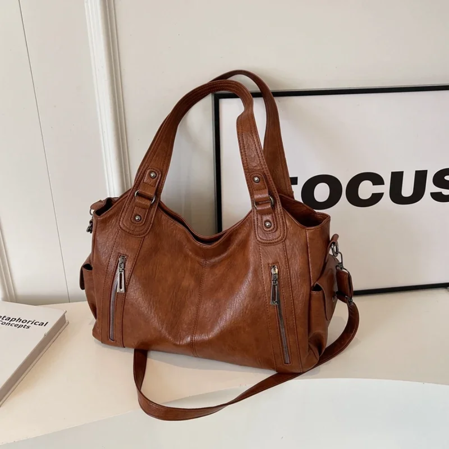 Elegant light brown faux leather duffle shoulder bag for women, ideal for stylish everyday carry.