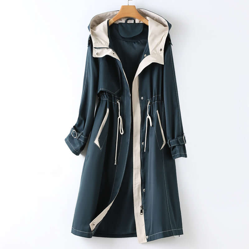 Blue women's hooded windbreaker jacket, lightweight & water-resistant. Ideal for spring, fall outdoor wear & travel.