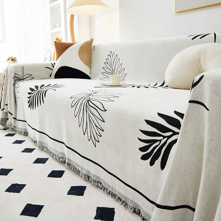 "Botanical sofa throw cover in stretchable protective fabric with elegant floral design fits snugly for modern home decor."