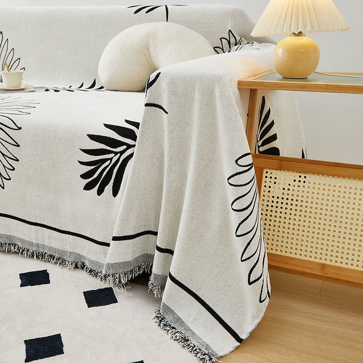 "Botanical sofa throw cover in stretchable protective fabric with elegant floral design fits snugly for modern home decor."