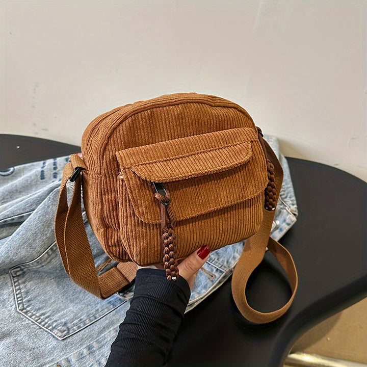 Brown women's small crossbody bag with front zip pocket, perfect for hands-free daily essentials.
