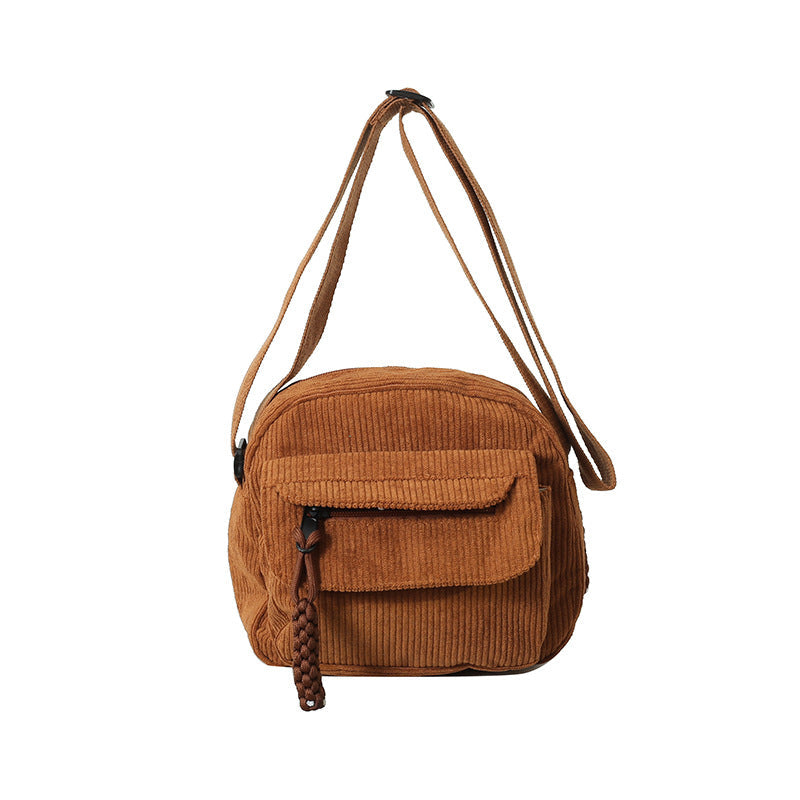 Compact black daily essential women's crossbody bag with a secure front zip pocket.