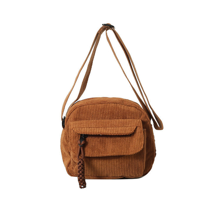 Compact black daily essential women's crossbody bag with a secure front zip pocket.