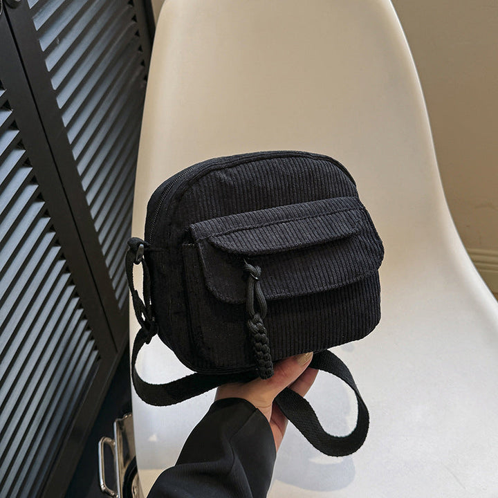 Chic black small crossbody bag for women, ideal for essentials with its front zip pocket.