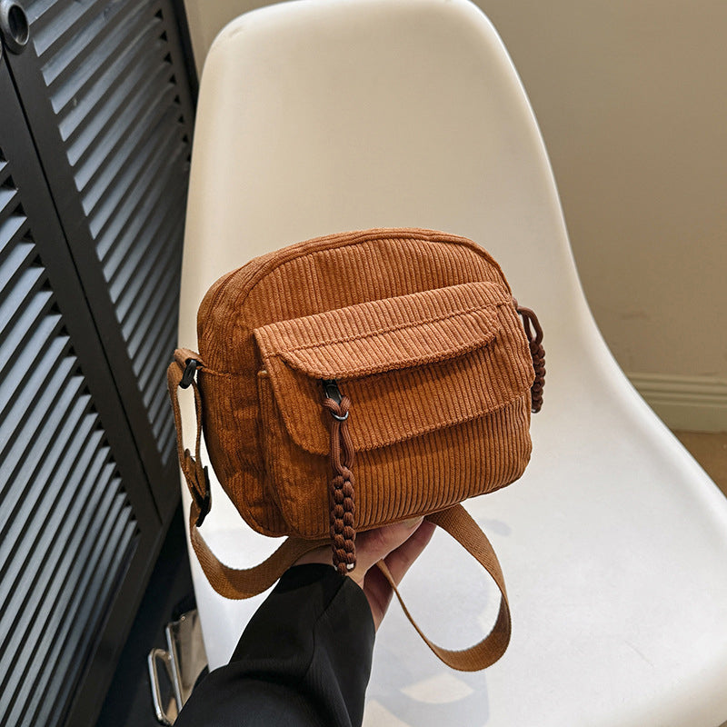 Vintage style brown small shoulder bag for women, featuring a practical front zip pocket.