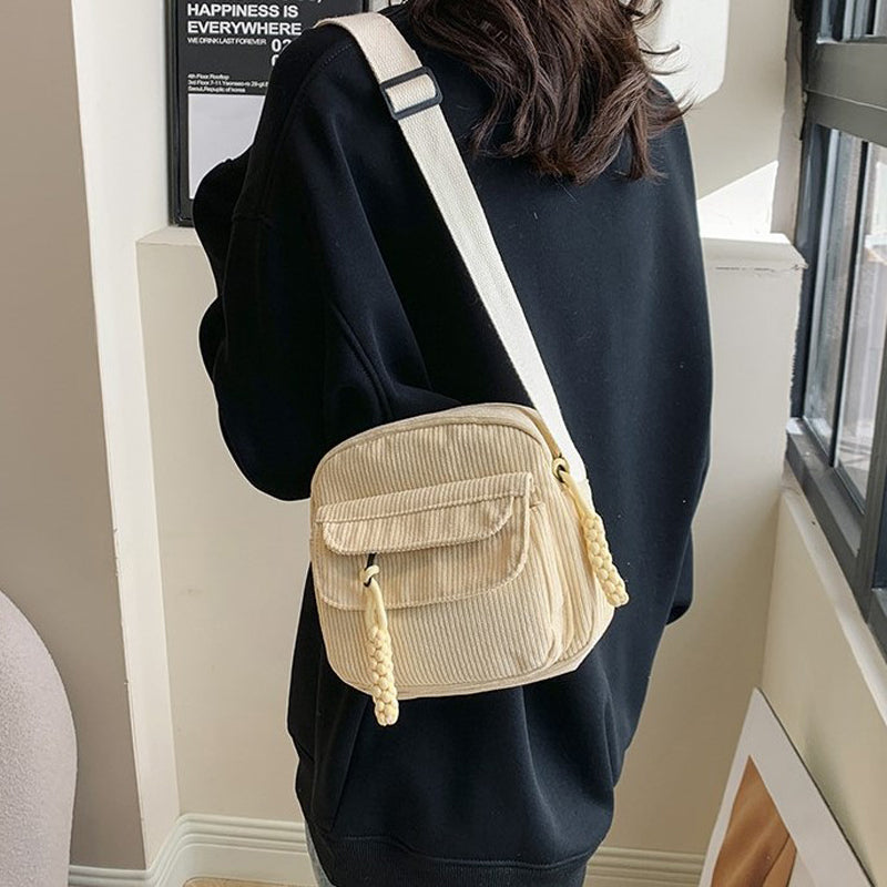 Women's beige vintage style small crossbody bag, perfect for essentials & hands-free use.