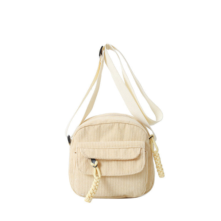 Light beige small crossbody bag for women, features a practical front zip pocket & adjustable strap.