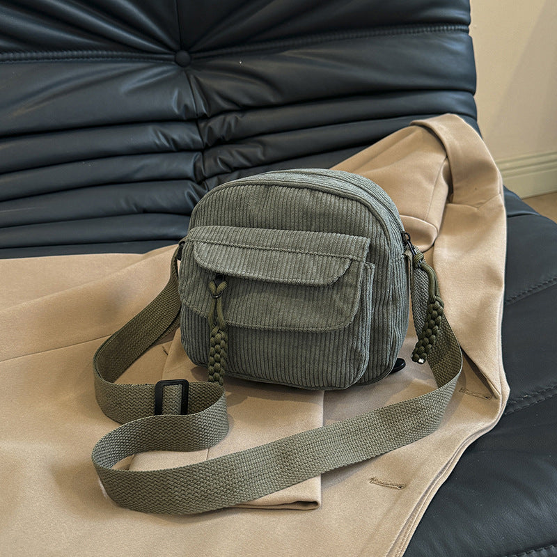 Olive green vintage style small shoulder bag for women, featuring a practical front zip pocket.