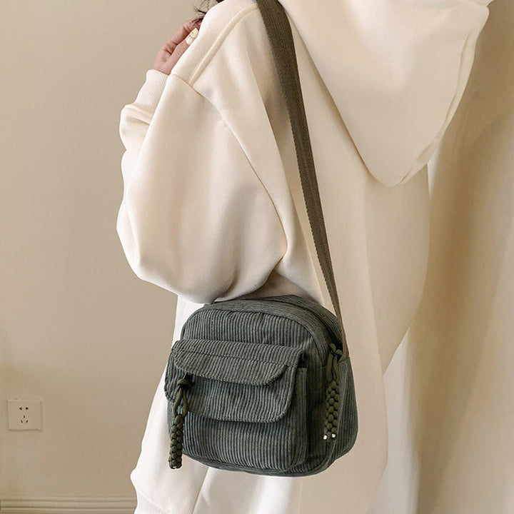 Chic green small crossbody bag for women, ideal for essentials with its front zip pocket.