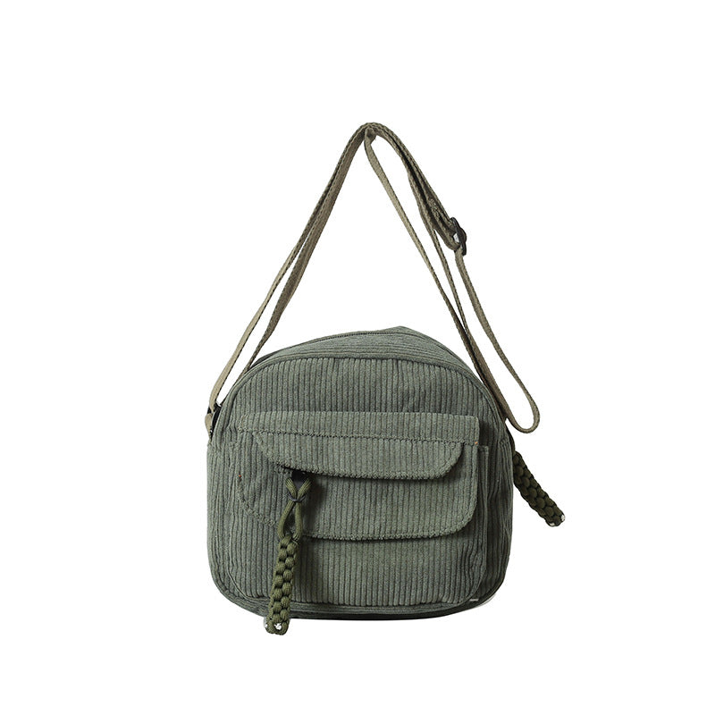 Stylish green women's small bag, crossbody design, with an accessible front zip pocket.