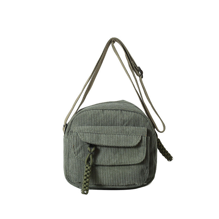 Stylish green women's small bag, crossbody design, with an accessible front zip pocket.