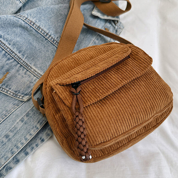 Hands-free brown women's accessory: small crossbody bag with a convenient front zip pocket.