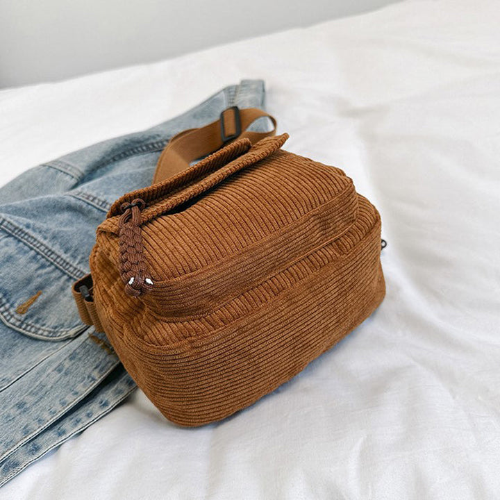 Chic brown small crossbody bag for women, ideal for essentials with its front zip pocket.