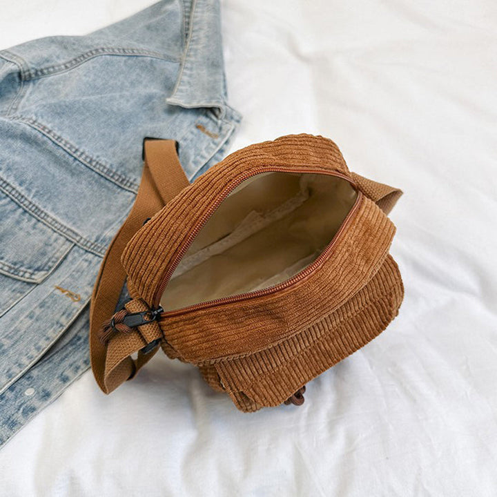 Stylish brown women's small bag, crossbody design, with an accessible front zip pocket.