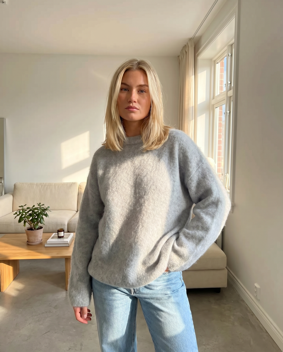 Elegant grey women's sweater, perfect for cozy layering and transitional weather, relaxed fit.