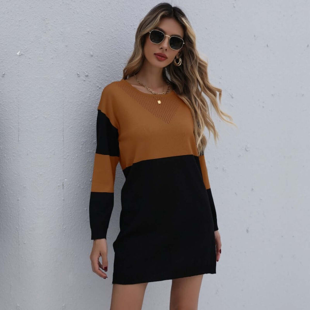 Woman wearing a cozy knitted winter dress in a neutral color
