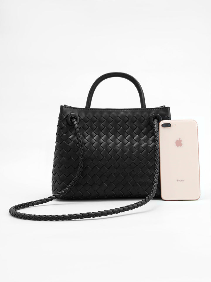 Structured black woven top handle bag with an elegant twist detail, a stylish women's accessory for any occasion.