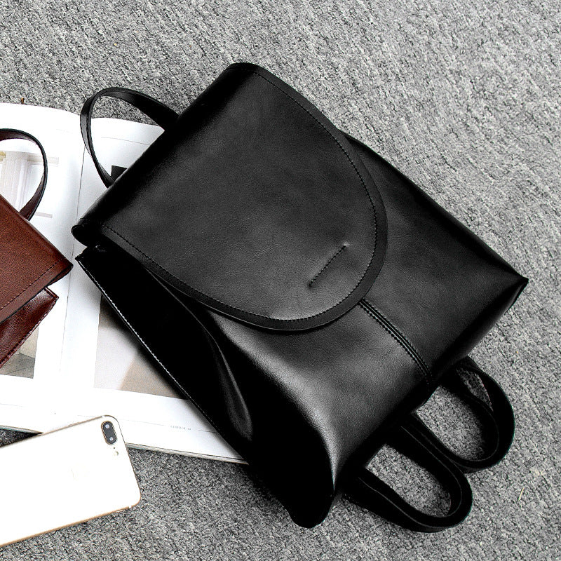 Stylish coffee genuine leather backpack, ideal everyday bag offering both elegance and practicality.