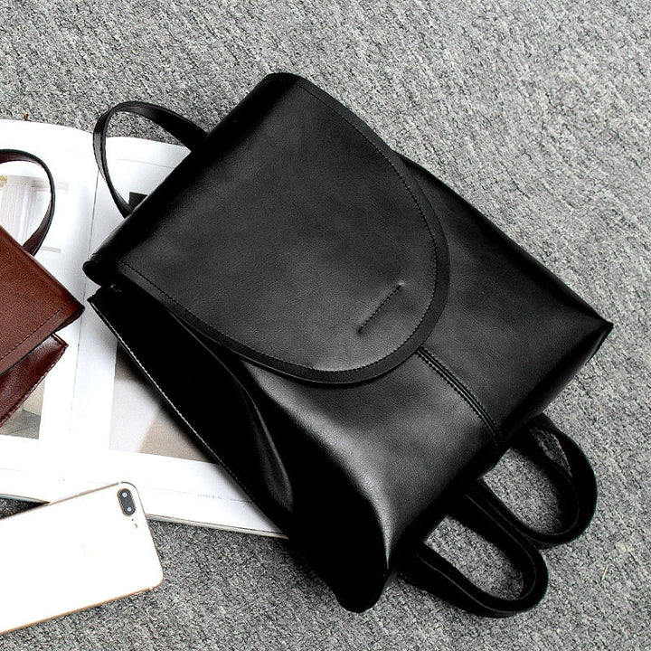 Stylish coffee genuine leather backpack, ideal everyday bag offering both elegance and practicality.