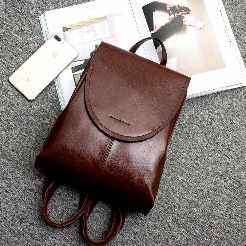 Women's chic blackish green leather backpack, a trendy and functional accessory for style-conscious travelers.