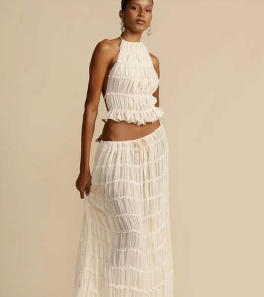 Stylish women's sleeveless halter top & short mini skirt set. Versatile two-piece outfit for summer casual or evening.