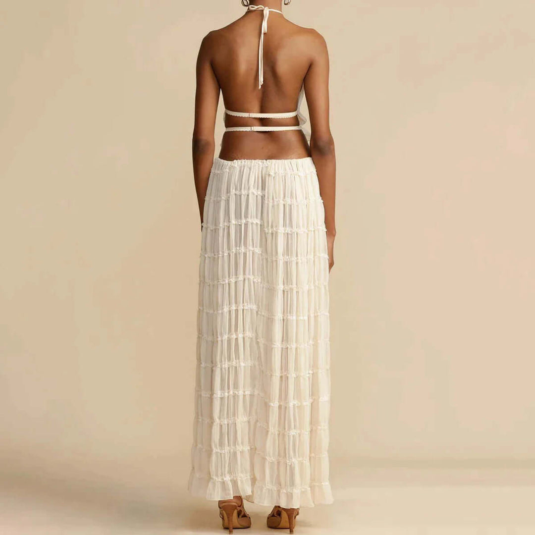 Fashionable white women's halter top and mini skirt set. A chic two-piece outfit for versatile summer styling.
