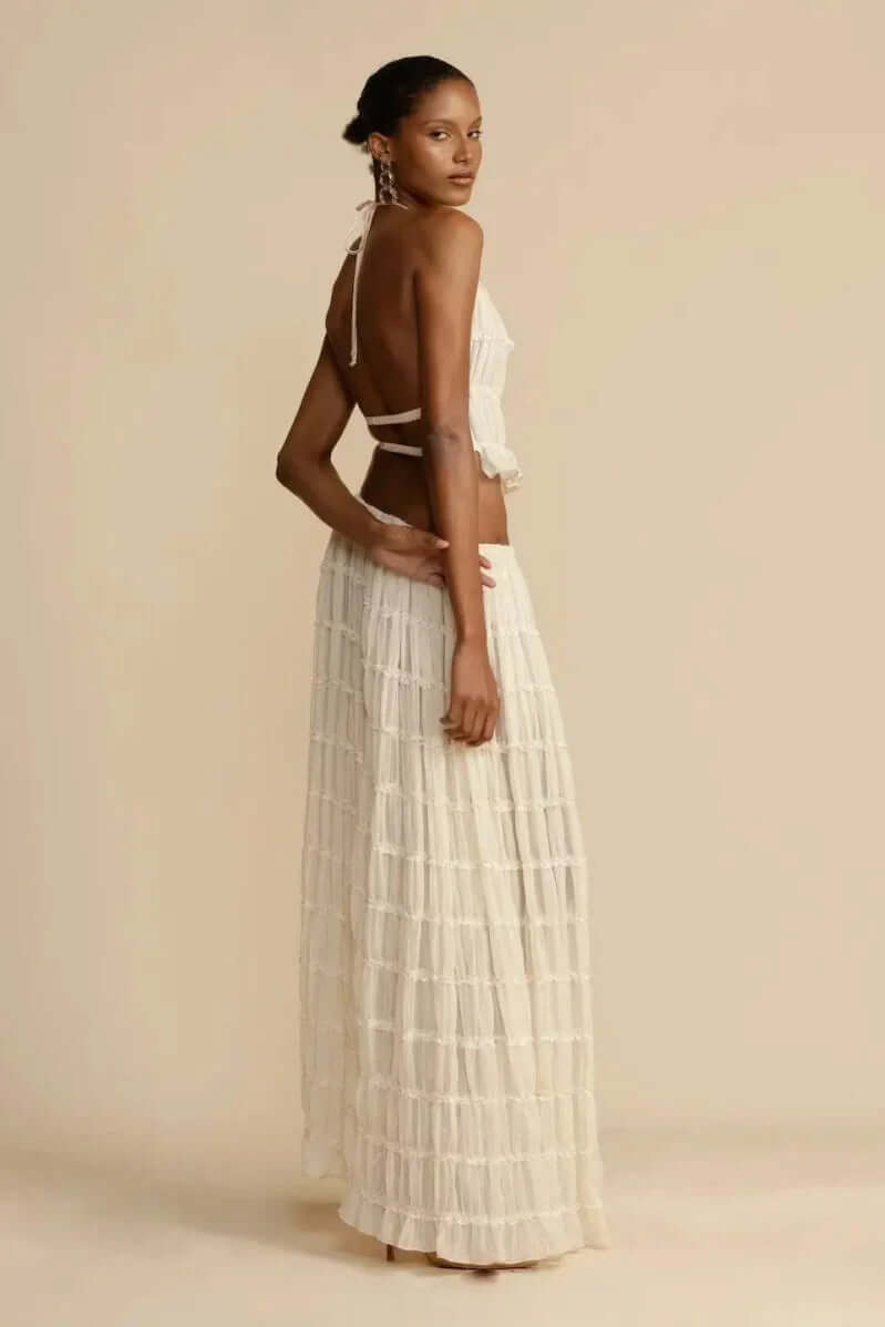 Trendy women's white halter top and mini skirt. This sleeveless short skirt set is perfect for summer events.