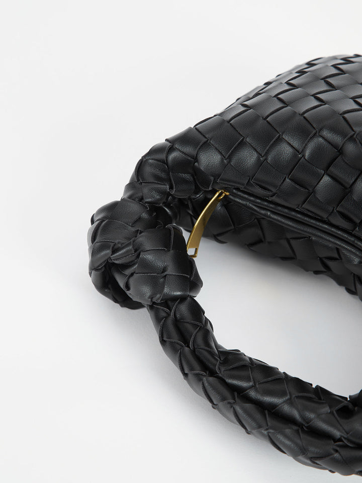 Elegant women's shoulder bag with stylish braided knot handles, a versatile and textured handbag accessory.