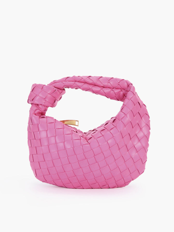 Close-up of a women's shoulder bag, highlighting its elegant braided knot handle & textured finish.