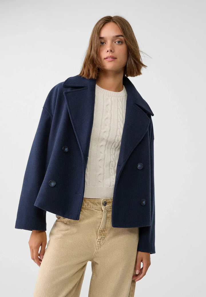 Stylish women's double-breasted cropped jacket. Modern short coat, perfect for a chic fall/winter look.