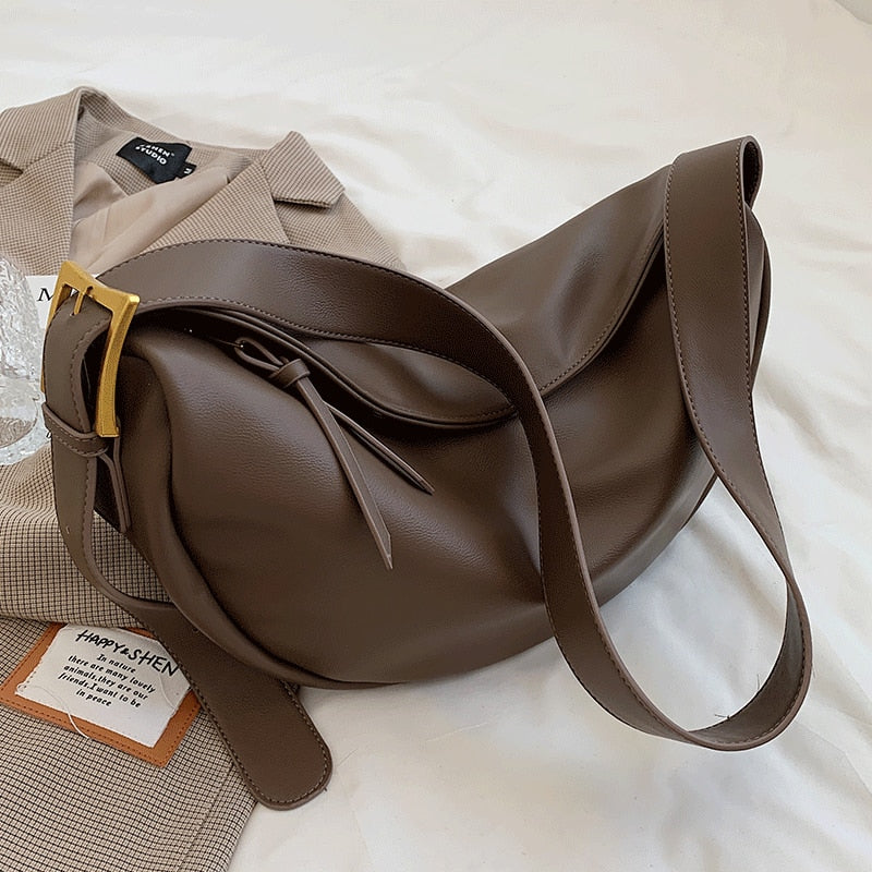 Modern women's handbag: elegant faux leather crossbody bag with adjustable shoulder strap for versatile everyday use.