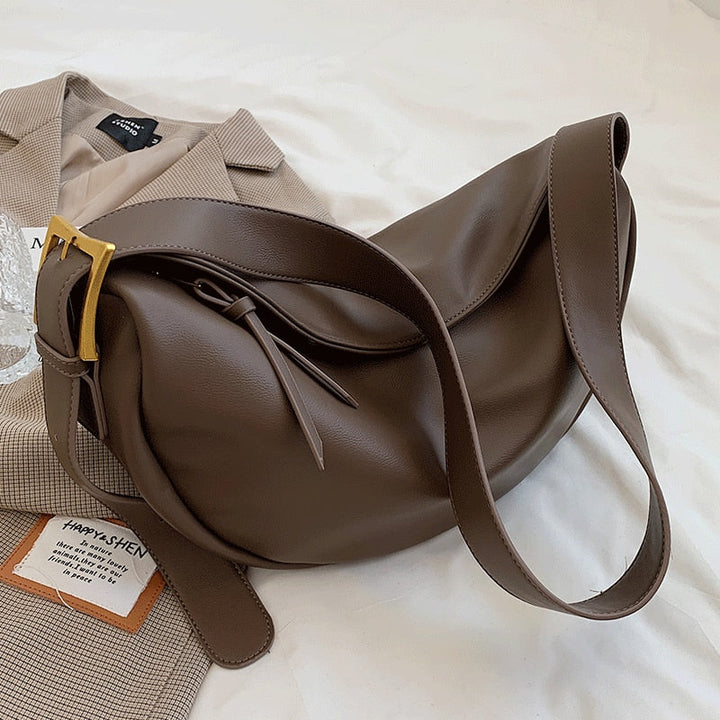 Modern women's handbag: elegant faux leather crossbody bag with adjustable shoulder strap for versatile everyday use.