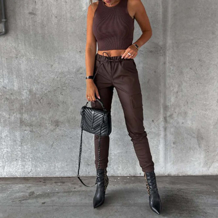 Women's faux leather cargo pants, high-waisted & tapered for a chic look. Versatile and edgy fashion trousers.