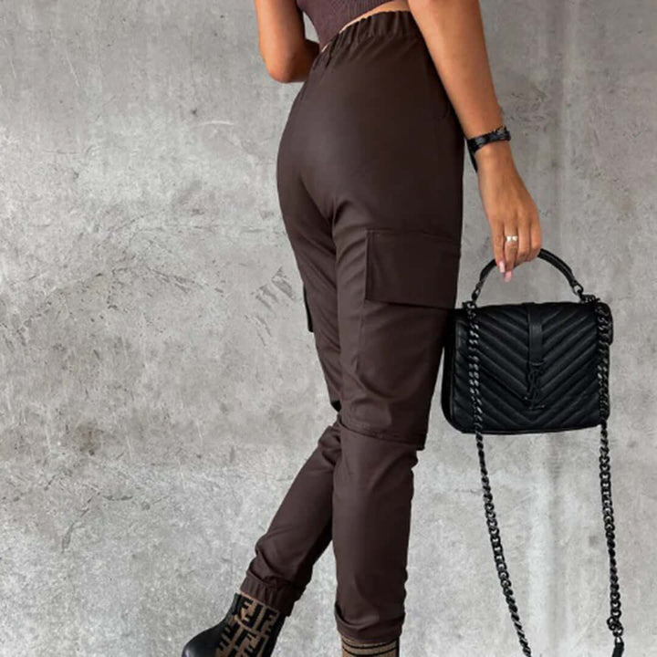 Modern women's high-waisted faux leather cargo trousers with a tapered leg. Edgy, chic & comfortable fashion bottoms.