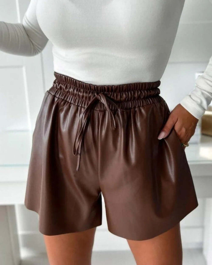 Comfortable women's faux leather drawstring shorts, relaxed fit for versatile casual or chic summer fashion.