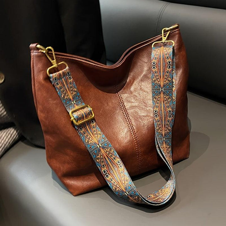 Chic women's faux leather shoulder bag with stylish embellished strap. Perfect fashion accessory for daily use.